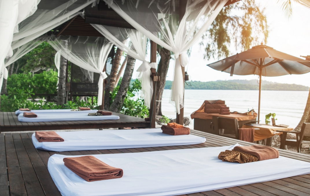 Daybeds and cabanas at a tranquil lakeside resort