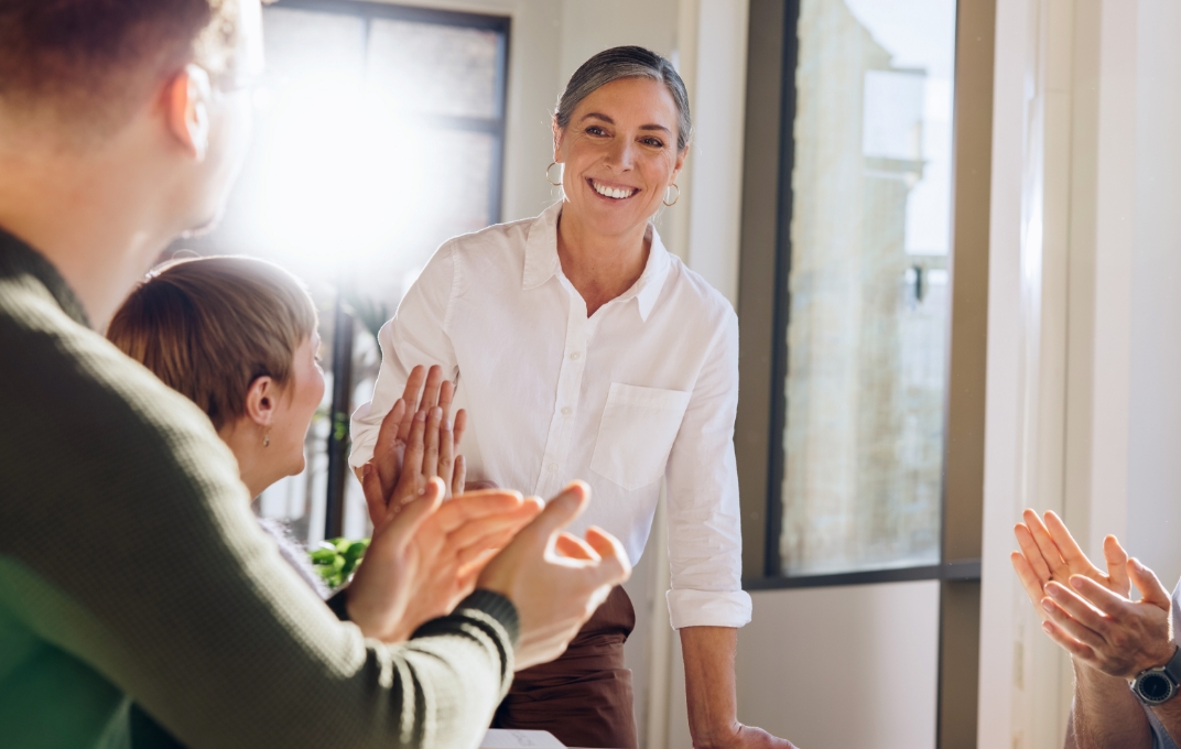 Colleagues applauding an employee at a milestone celebration