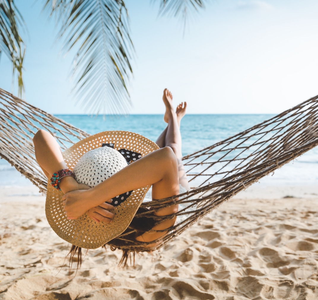 Traveler relaxing in a hammock on a tropical beach